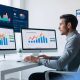 Entrepreneur using AI marketing tools on desktop with rising productivity charts